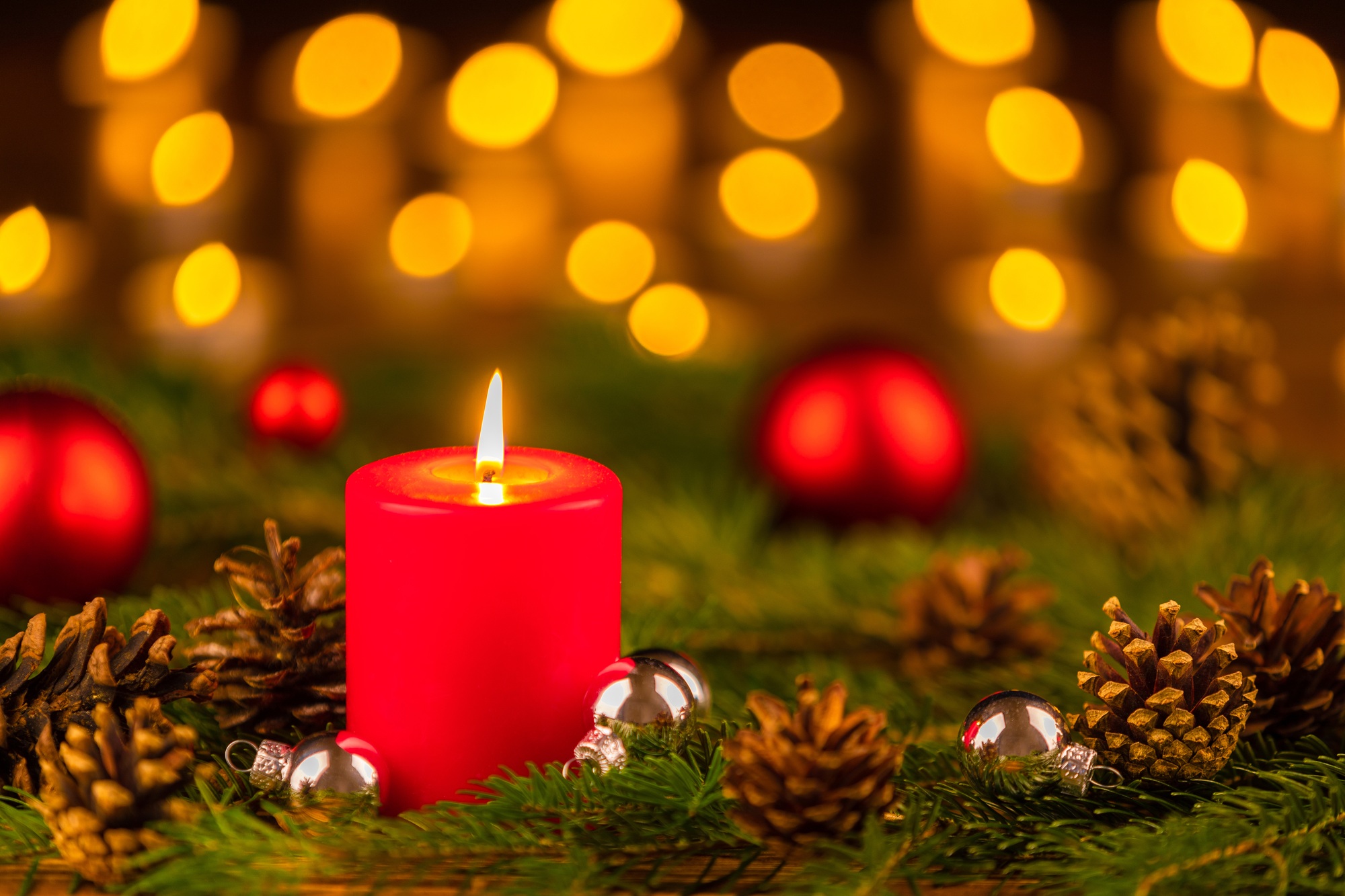 Selective focus shot of Christmas ornaments and a candle